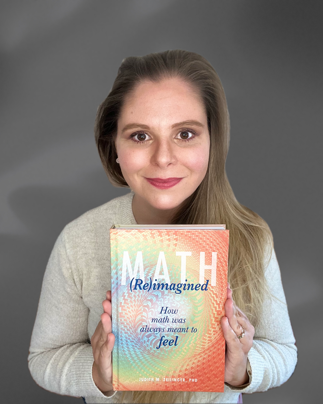 Judith Zeilinger holds her book "Math (Re)Imagined: How math was always meant to feel"