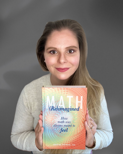 Judith Zeilinger holds her book "Math (Re)Imagined: How math was always meant to feel"